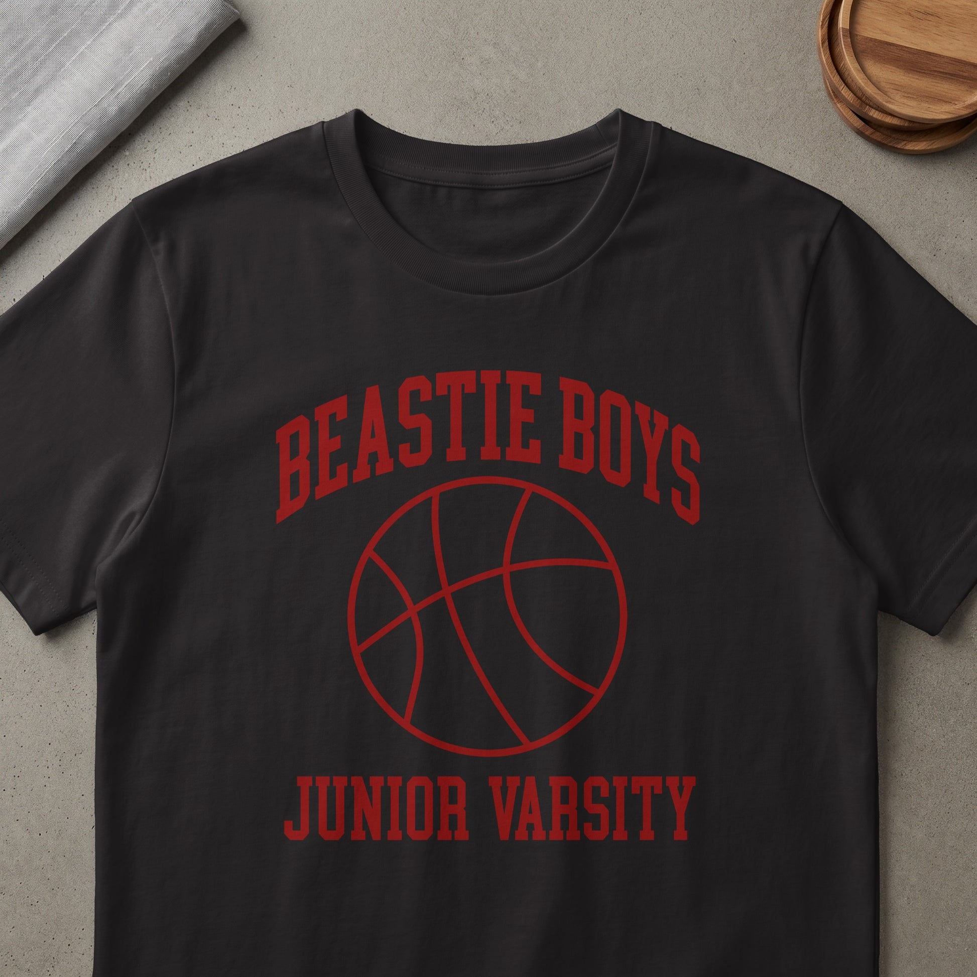 Black t-shirt with red Beastie Boys Junior Varsity basketball graphic.