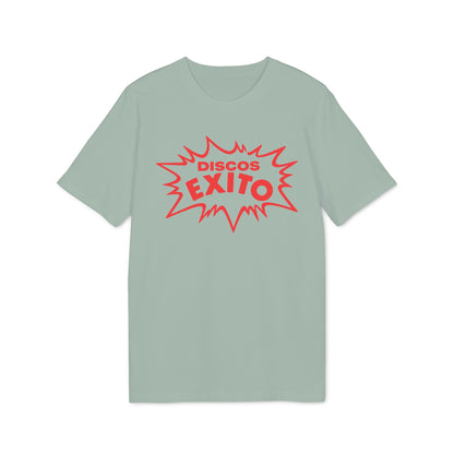 A sage green short-sleeved t-shirt featuring a red graphic with the text DISCOS EXITO inside a jagged comic-style explosion shape.