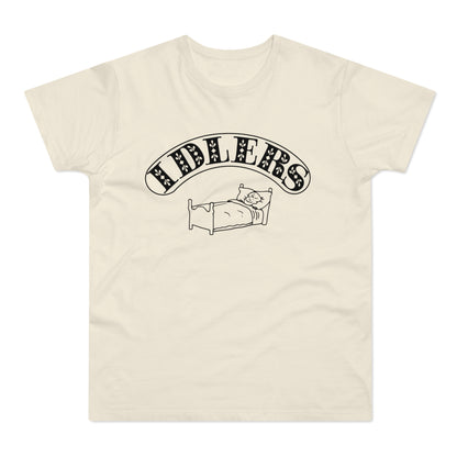 Cream t-shirt with black text and cartoon cat sleeping in a bed.