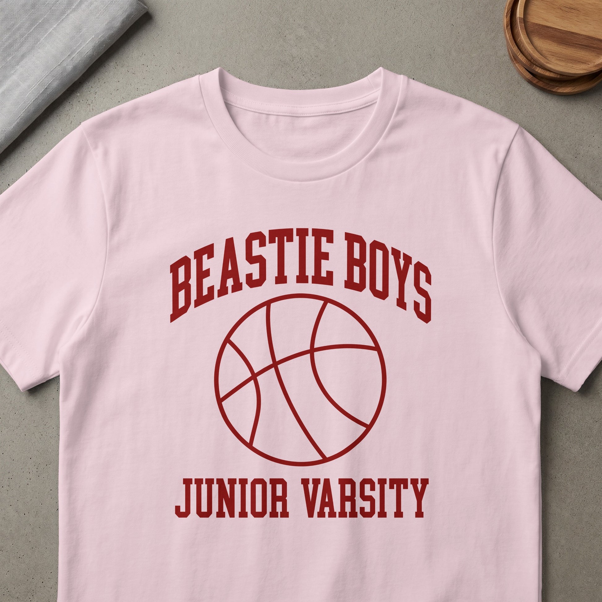 Pink t-shirt with "Beastie Boys Junior Varsity" text and a basketball graphic.