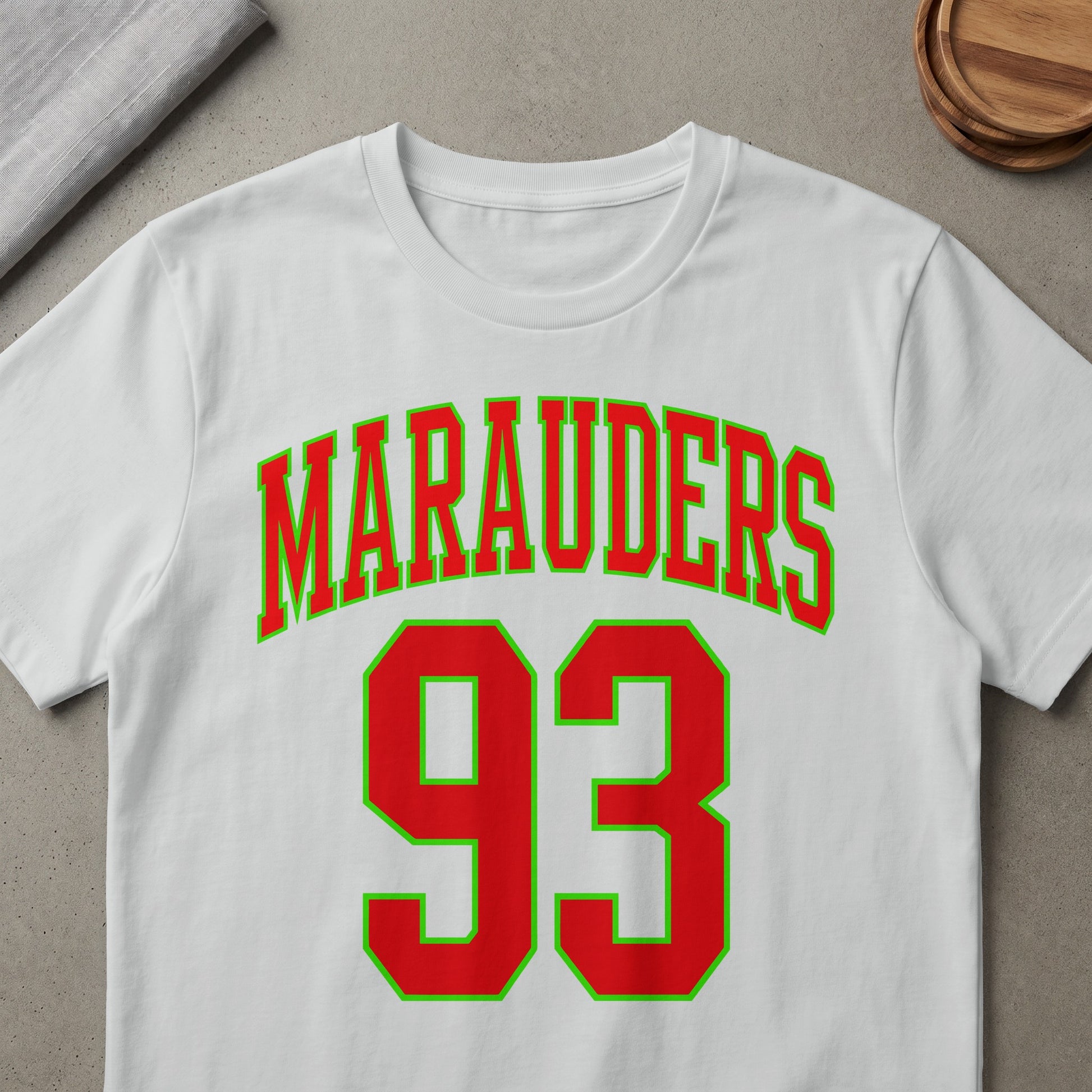 White t-shirt with red and green "MARAUDERS 93" graphic design.
