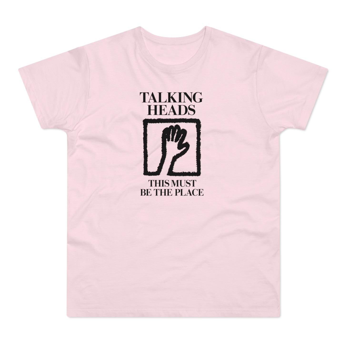 Pink t-shirt with "Talking Heads" and "This Must Be The Place" text and hand graphic.