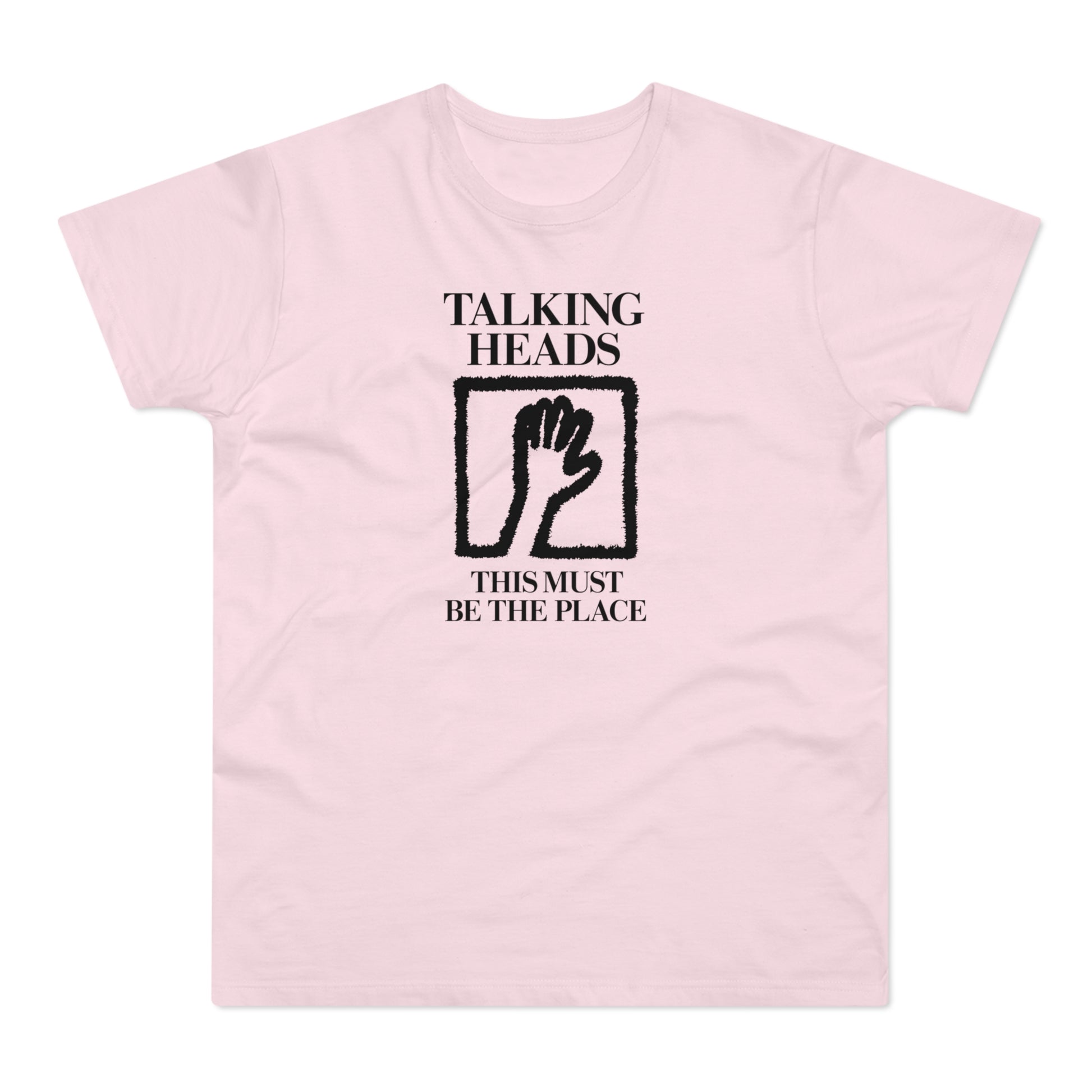 Pink t-shirt with "Talking Heads" and "This Must Be The Place" text and hand graphic.