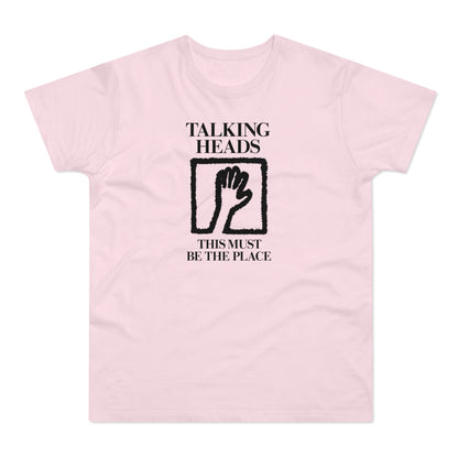 Pink t-shirt with "Talking Heads" and "This Must Be The Place" text and hand graphic.