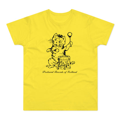 Yellow t-shirt with black drawing of a cat playing a drum, text "Postcard Records of Scotland".