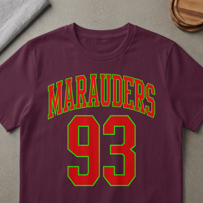 Maruaders 93 text in red with green outline on a maroon t-shirt.