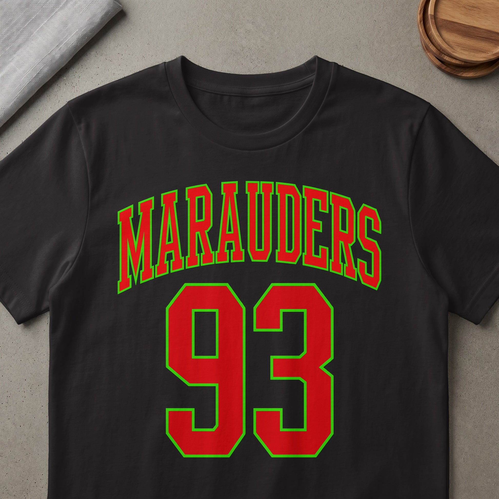 Black t-shirt with red "Marauders" text and red number "93" with green outlines.